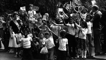 archive photo of smiling children waving union jack flags in honour of silver jubilee © RSPCA