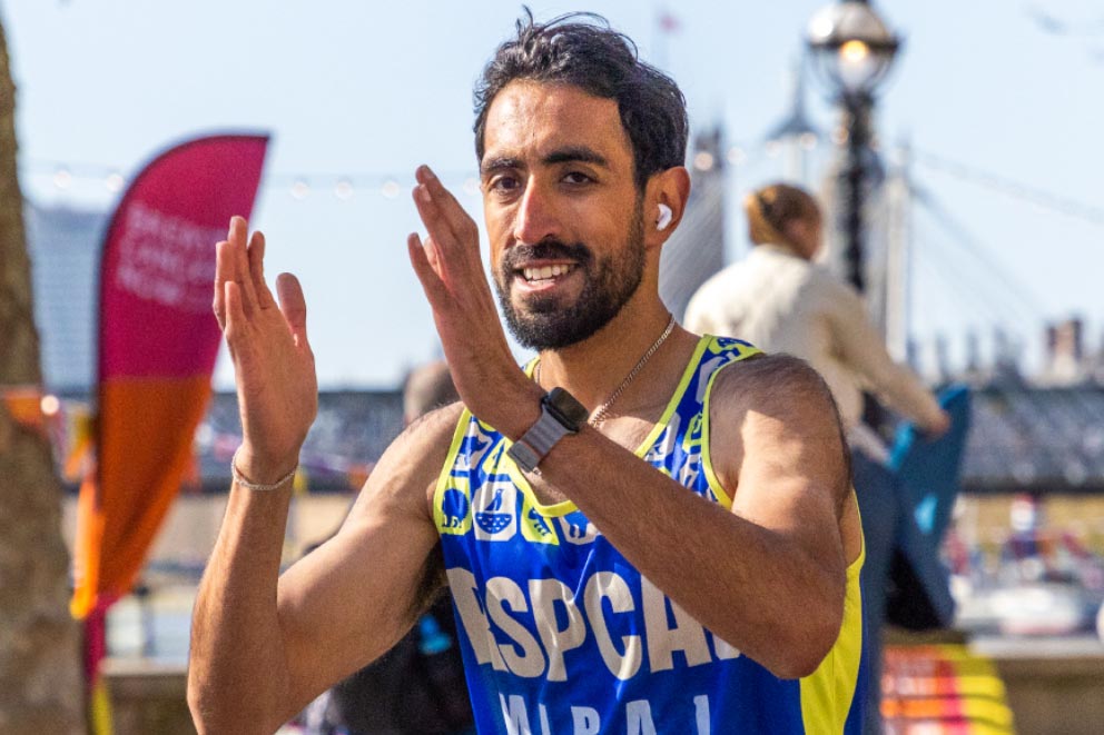 An RSPCA fundraiser wearing a running vest completing a running event.