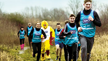 RSPCA supporters on a run wearing RSPCA branded vests © RSPCA