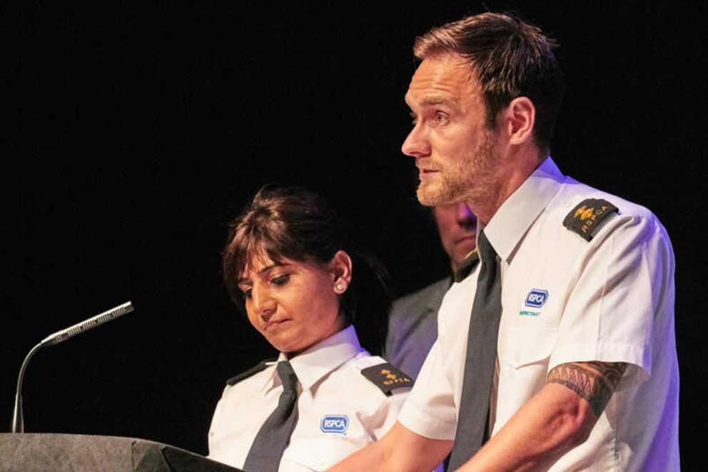 Two RSPCA inspectors presenting at a conference.