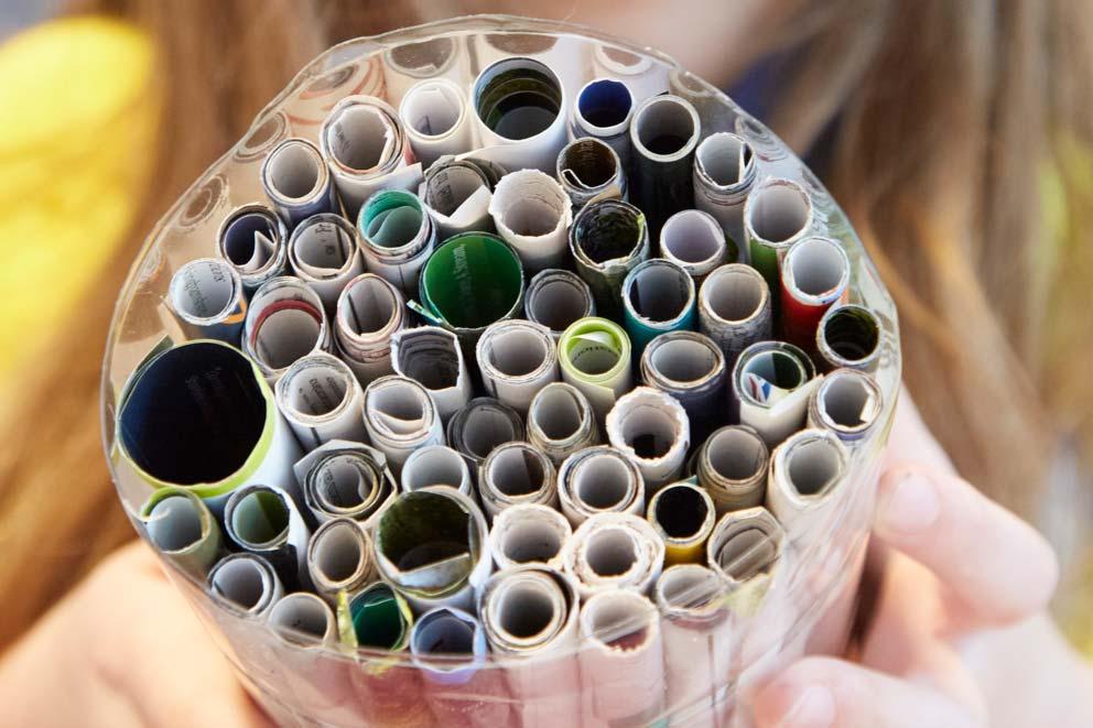 Paper rolled into tubes ready for use in a recycled craft activity.