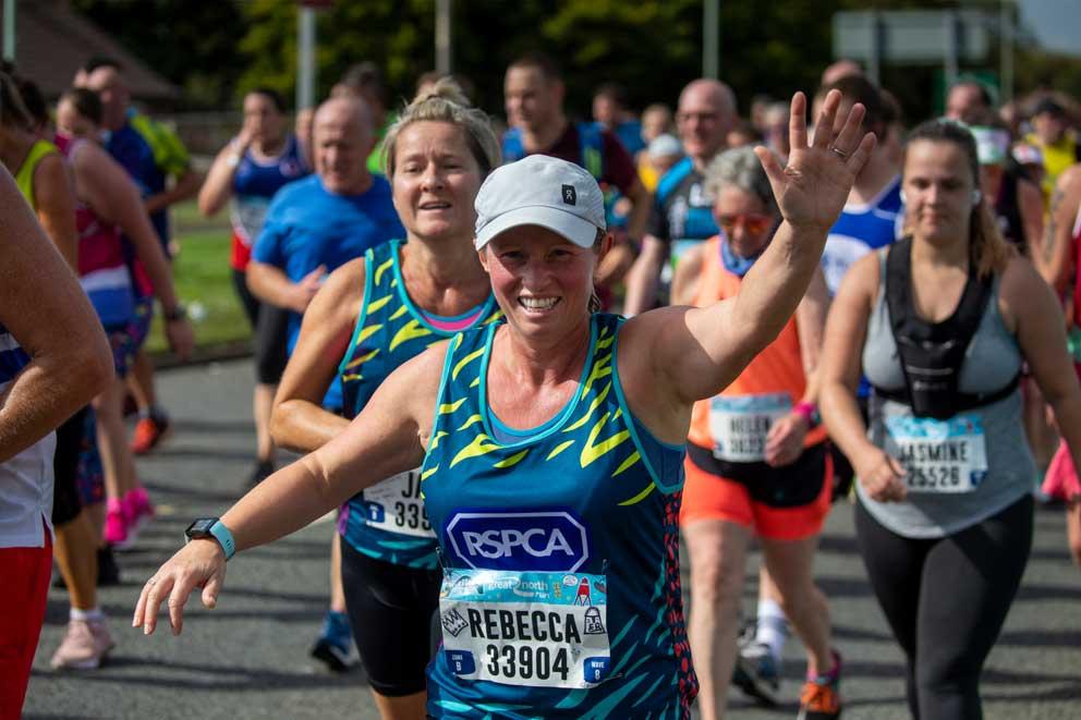 Smiling and waving RSPCA runner.