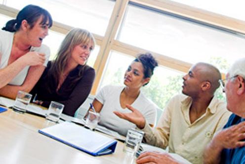 five volunteers in discussion meeting