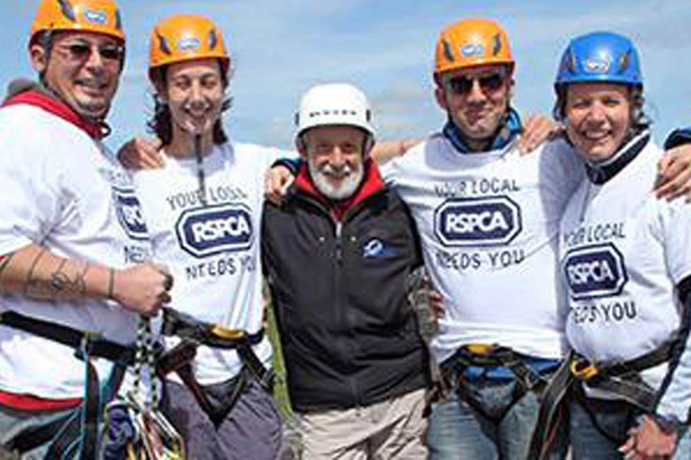 A group of fundraisers wearing abseiling gear.