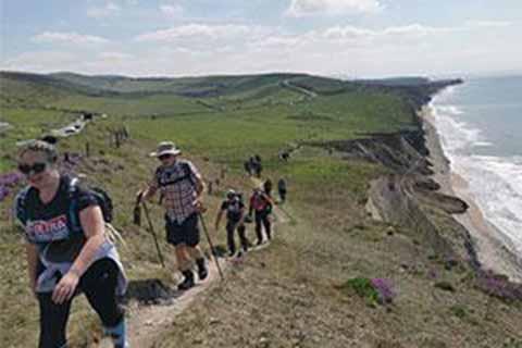 A group of trekkers walking the Isle of Wight coastal path.