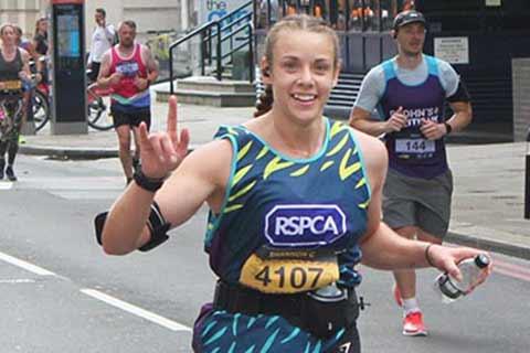 An RSPCA runner waving.