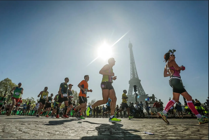 Event runners running past the Eiffel tower in Paris.