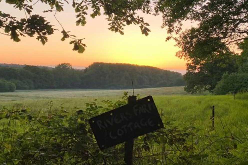 Early morning sunrise across a field looking to the South Down ridge.