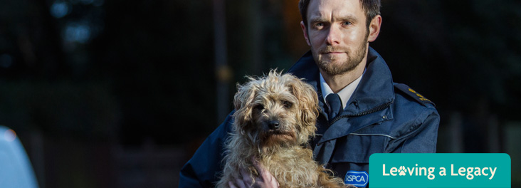 RSPCA Inspector Anthony Joynes holding a dog © RSPCA