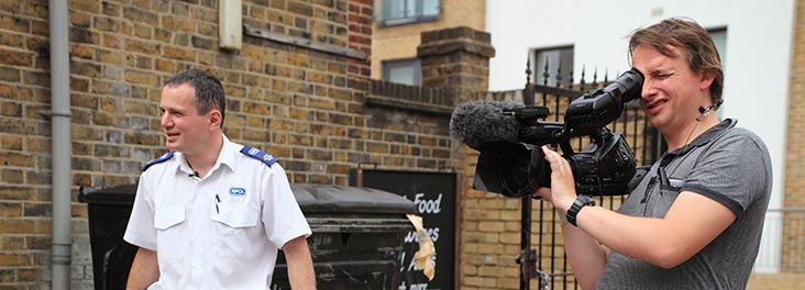 RSPCA Animal Collection Officerstanding with Sky television film crew © RSPCA photolibrary